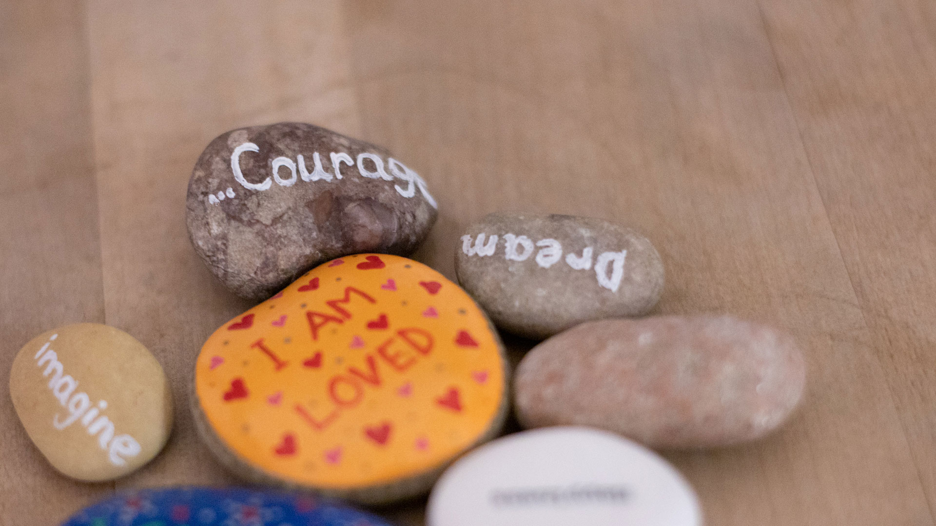 Stones with positive messages painted on