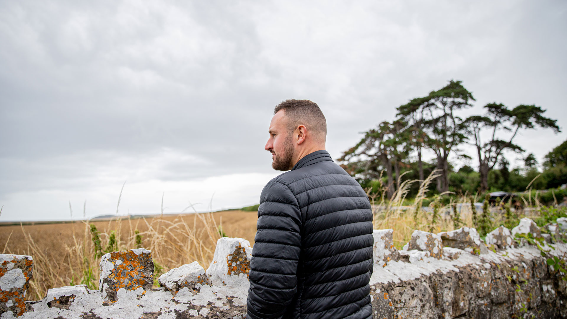 Man overlooking wall in the countryside